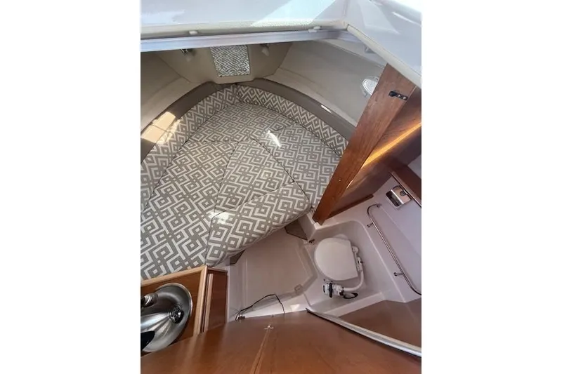 Slide: The Image of 2024 Cutwater 248 boat interior with patterned seating and compact bathroom. - 17