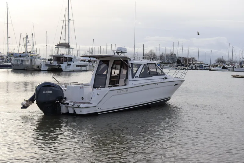 Slide: The Image of 2024 Cutwater 248 boat in marina, featuring Yamaha outboard motor. - 2