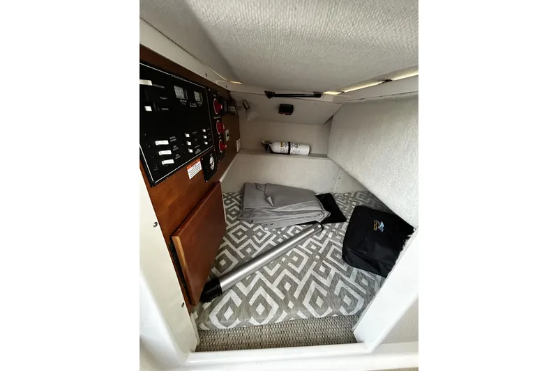 Slide: The Image of 2024 Cutwater 248 interior cabin with control panel and storage area. - 21