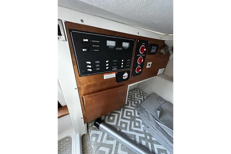 Slide: The Image of 2024 Cutwater 248 boat interior control panel with switches and gauges. - 22