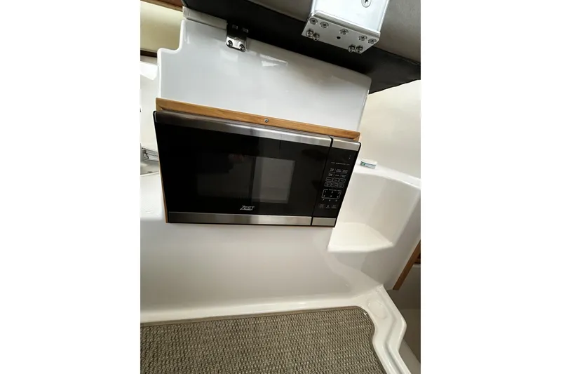 Slide: The Image of 2024 Cutwater 248 interior with built-in microwave and modern design. - 24