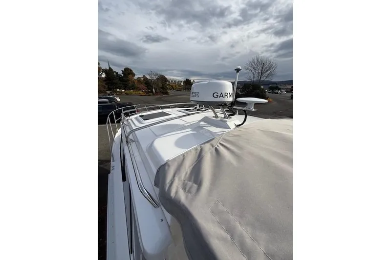 Slide: The Image of 2024 Cutwater 248 boat with Garmin radar, covered deck, and overcast sky. - 26