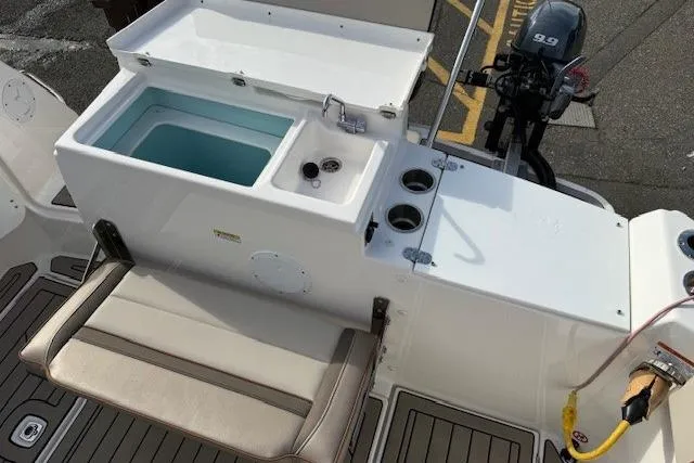 Slide: The Image of 2024 Cutwater 248 boat interior with seating, storage, and motor. - 27