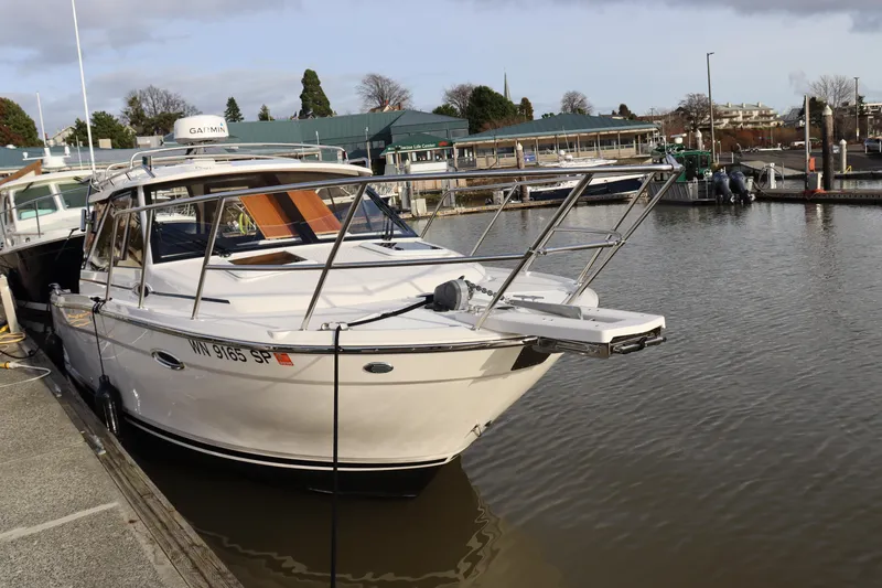 Slide: The Image of 2024 Cutwater 248 boat docked at a marina, showcasing sleek design and modern features. - 4