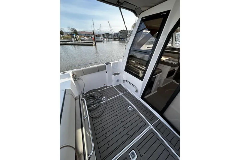 Slide: The Image of 2024 Cutwater 248 boat interior with sleek deck design and marina view. - 5