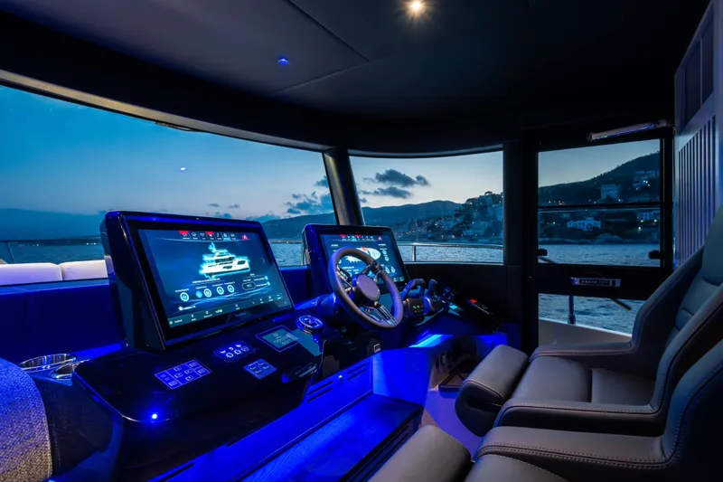 Slide: The Image of Luxurious 2027 Absolute Navetta 66 yacht cockpit with advanced navigation screens at dusk. - 51