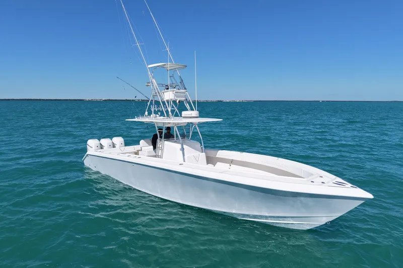 Slide: The Image of 2005 Venture 39 Open boat on clear blue ocean under sunny sky. - 1