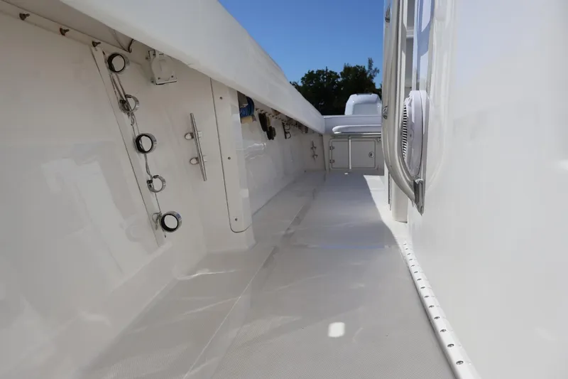 Slide: The Image of 2005 Venture 39 Open boat interior, showcasing sleek white deck and storage compartments. - 10