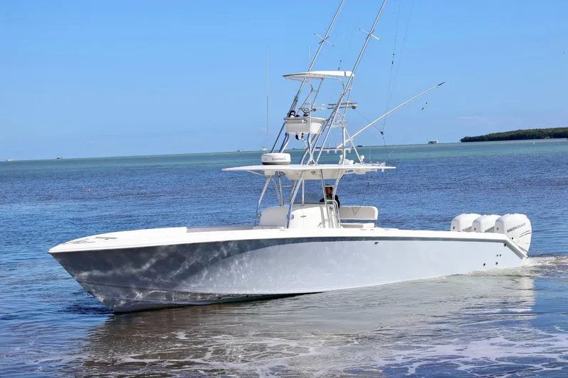 Slide: The Image of 2005 Venture 39 Open boat on calm waters, clear sky background. - 21