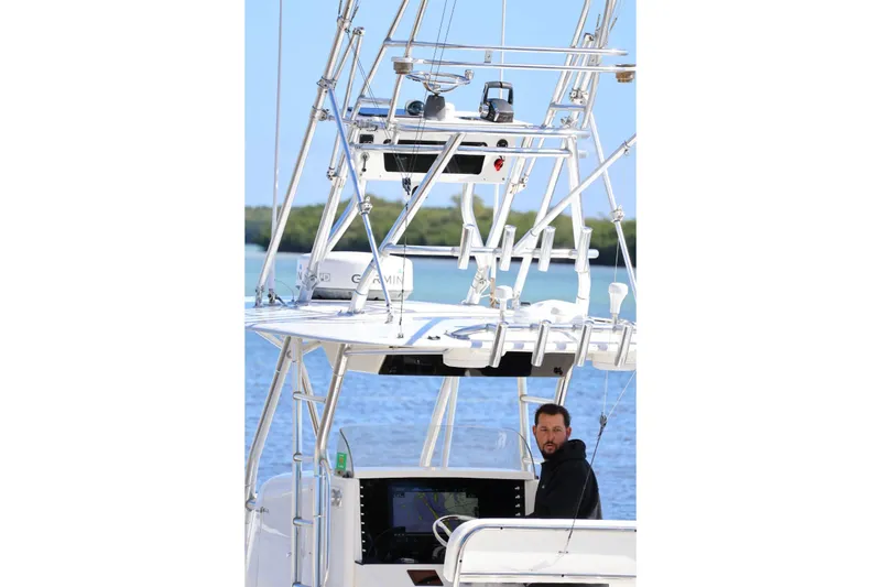 Slide: The Image of 2005 Venture 39 Open boat with a person at the helm, navigating on water. - 5