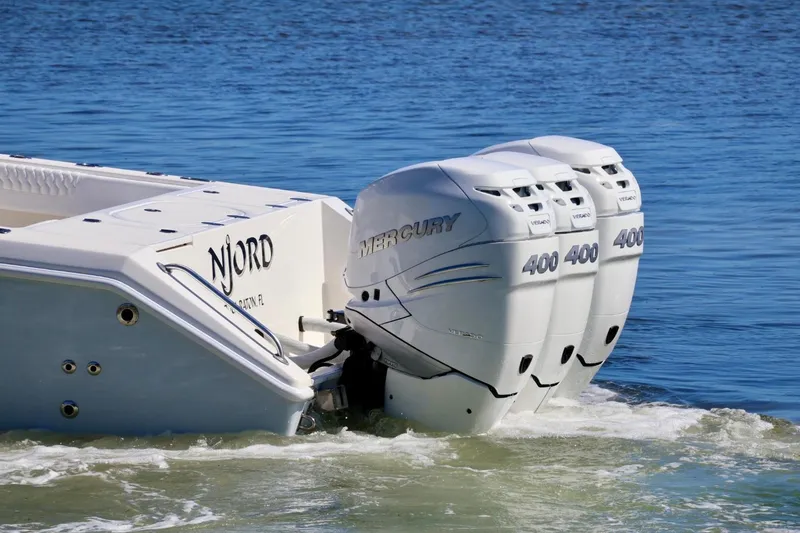 Slide: The Image of 2005 Venture 39 Open boat with triple Mercury 400 engines on water. - 6