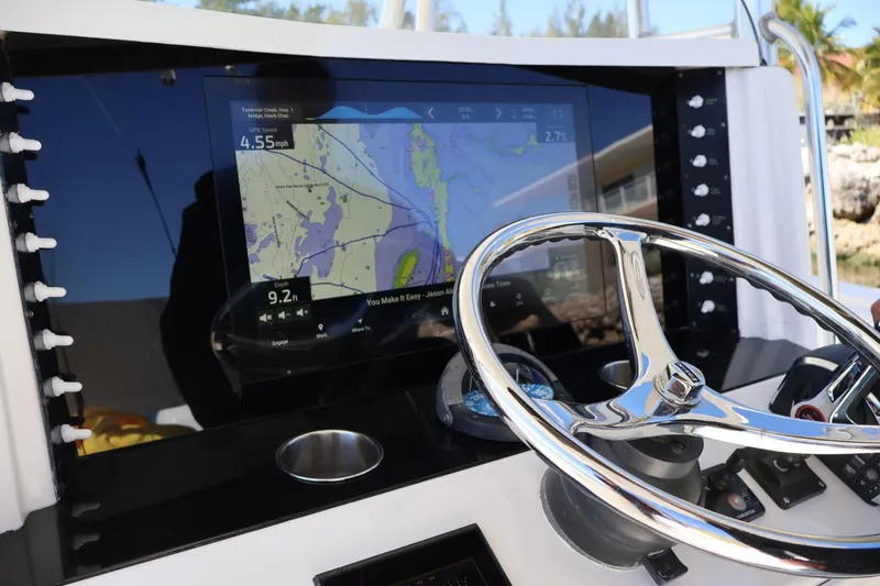Slide: The Image of Helm of 2005 Venture 39 Open boat with navigation display and steering wheel. - 7