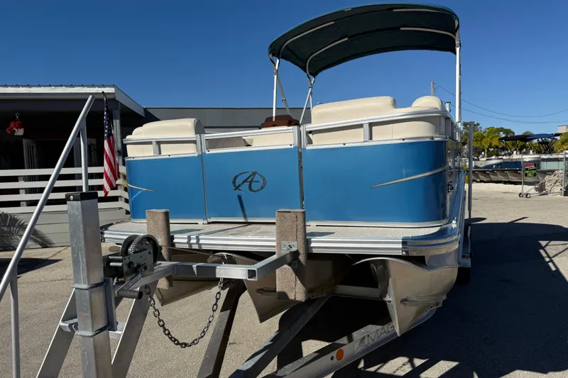 Slide: The Image of 2020 Avalon 2280 Venture Quad Lounger pontoon boat on trailer, blue exterior, sunny day. - 3