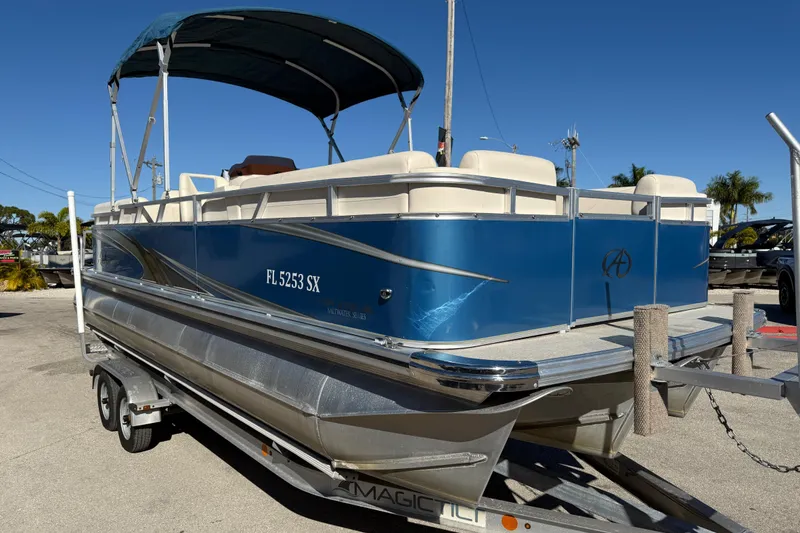Slide: The Image of 2020 Avalon 2280 Venture Quad Lounger pontoon boat on trailer, blue exterior. - 4