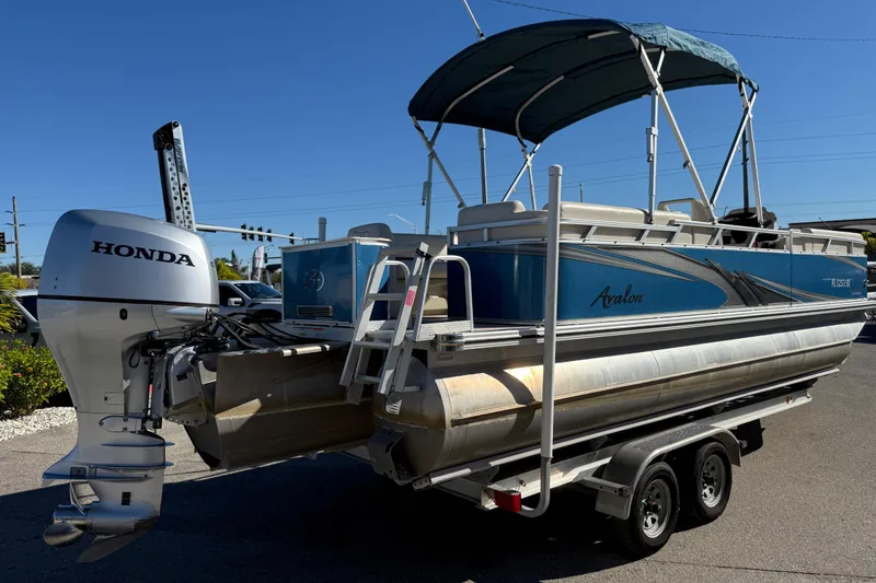 Slide: The Image of 2020 Avalon 2280 Venture Quad Lounger pontoon boat with Honda outboard motor on trailer. - 5