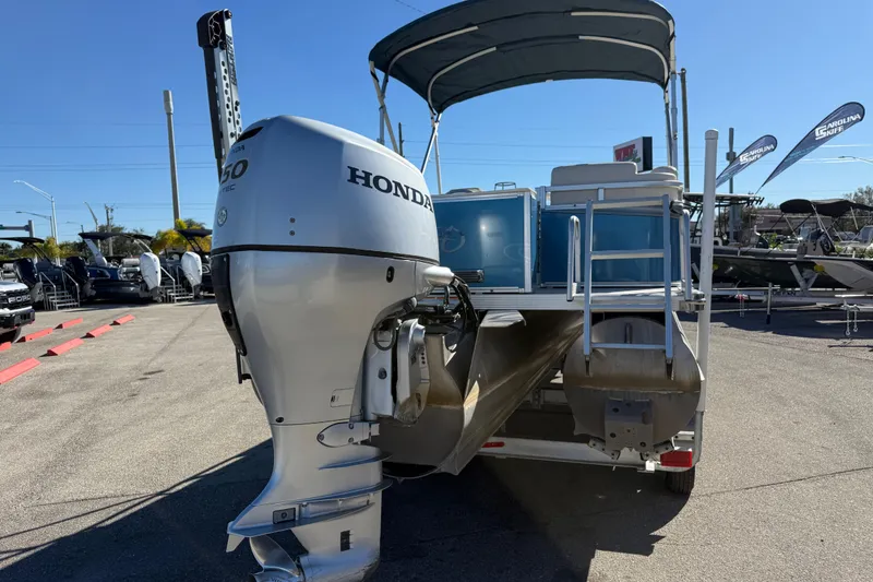 Slide: The Image of 2020 Avalon 2280 Venture Quad Lounger with Honda outboard motor, parked outdoors. - 7