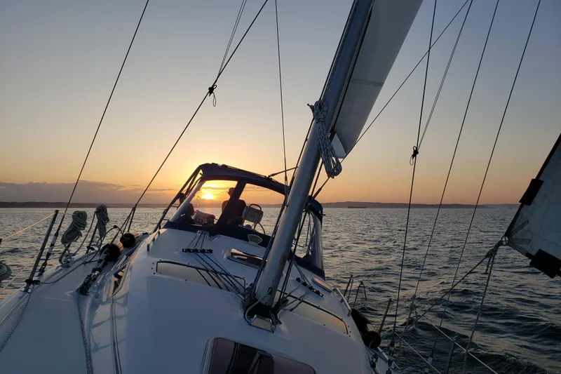 Slide: The Image of Sailing on a 2009 Hunter 38 yacht at sunset over calm waters. - 25