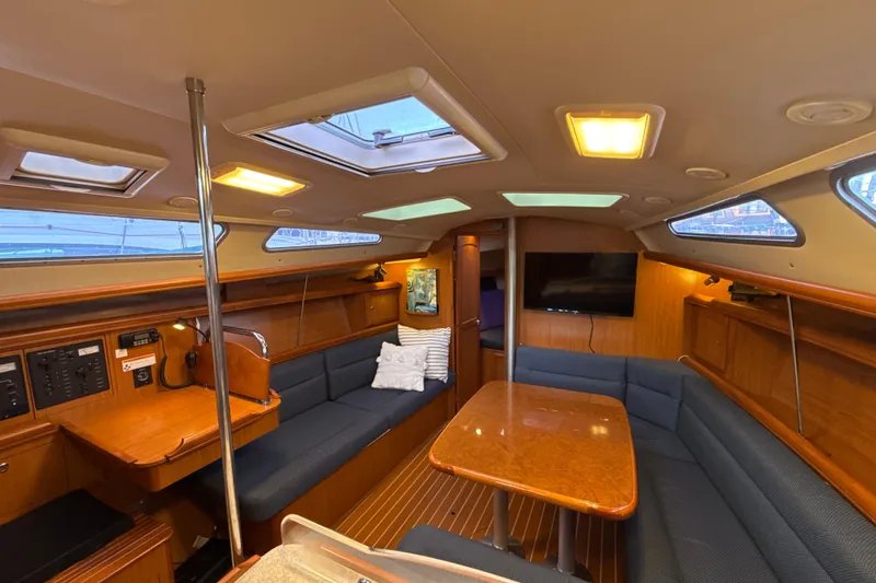Slide: The Image of Interior of 2009 Hunter 38 sailboat with cozy seating and wooden finishes. - 3