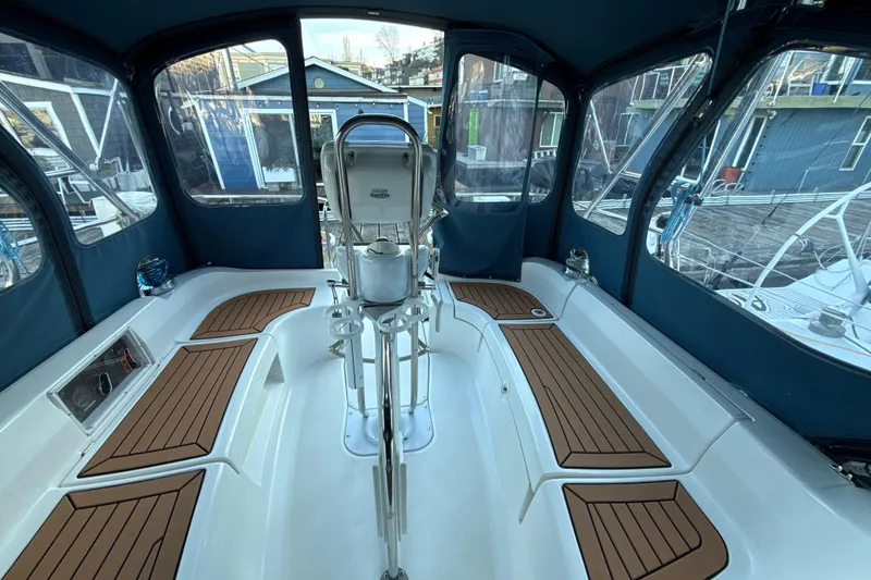 Slide: The Image of Interior view of a 2009 Hunter 38 sailboat cockpit with wooden seating. - 5