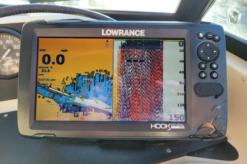 Slide: The Image of Lowrance fish finder display on 1998 Arima Sea Ranger 19 boat, showing sonar and navigation data. - 13