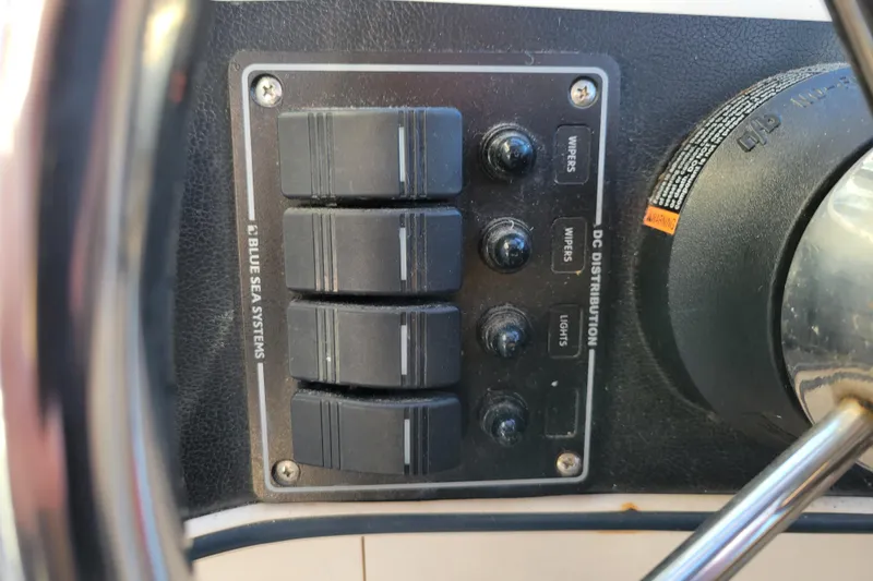 Slide: The Image of Control panel of a 1998 Arima Sea Ranger 19 boat with switches and labels. - 16