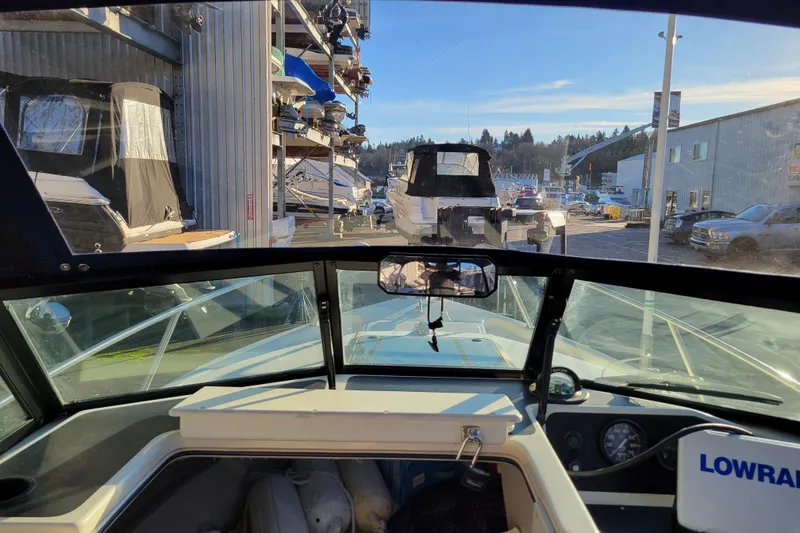 Slide: The Image of Interior view of a 1998 Arima Sea Ranger 19 boat at a marina. - 18