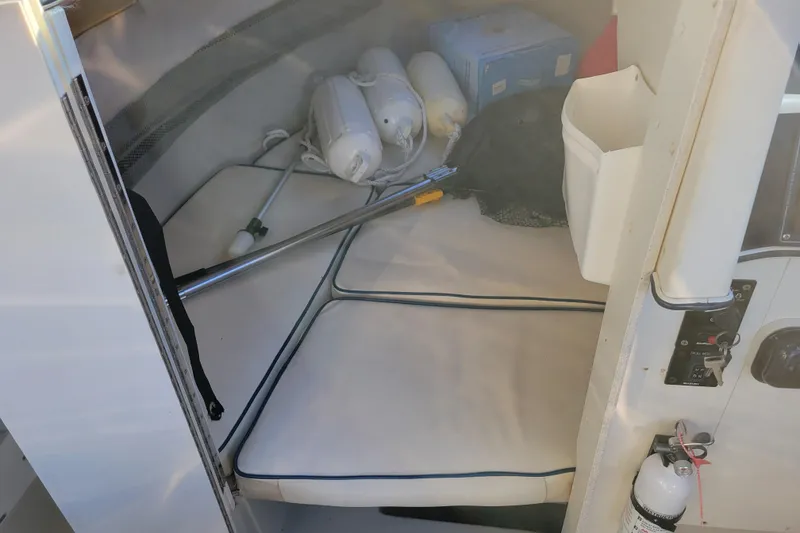 Slide: The Image of Interior of 1998 Arima Sea Ranger 19 boat with cushions and safety equipment. - 19