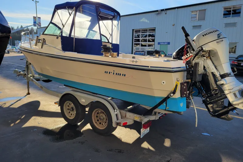 Slide: The Image of 1998 Arima Sea Ranger 19 boat on trailer with Honda outboard motor. - 5
