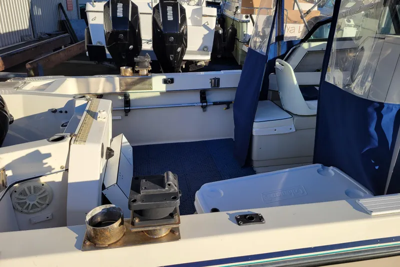 Slide: The Image of 1998 Arima Sea Ranger 19 boat interior with seating and dual outboard motors. - 6