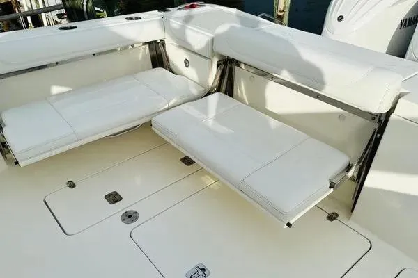 Slide: The Image of 2023 Pursuit OS 355 Offshore boat with white cushioned seating and deck. - 3