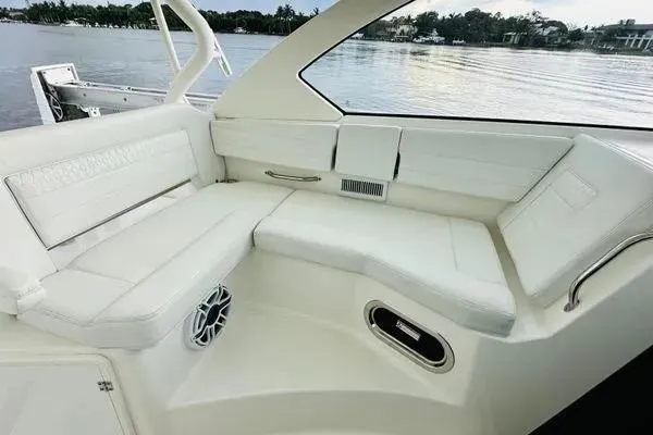 Slide: The Image of 2023 Pursuit OS 355 Offshore boat interior with white seating and scenic water view. - 4