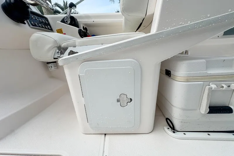 Slide: The Image of Interior of 2014 Everglades 230 Dual Console boat showing seating and storage compartments. - 101