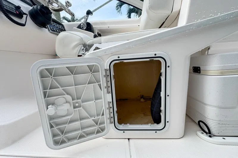 Slide: The Image of Open storage compartment on 2014 Everglades 230 Dual Console boat interior. - 102