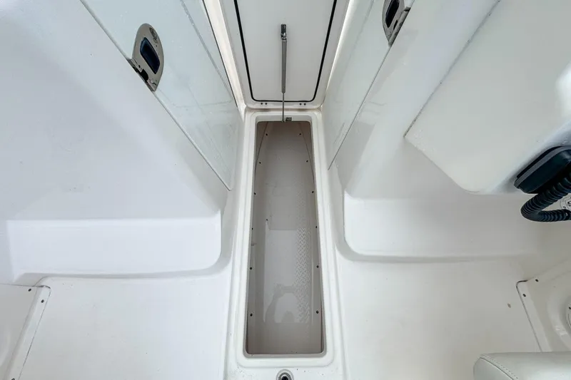 Slide: The Image of 2014 Everglades 230 Dual Console boat interior storage compartment, white finish. - 105