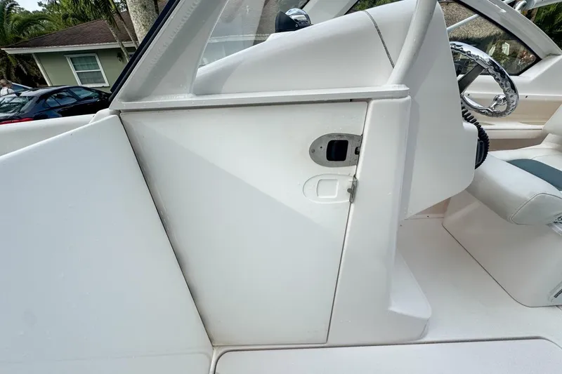 Slide: The Image of 2014 Everglades 230 Dual Console boat interior with steering wheel and seating area. - 108