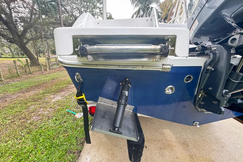 Slide: The Image of Rear view of 2014 Everglades 230 Dual Console boat, showing trim tabs and motor mount. - 19