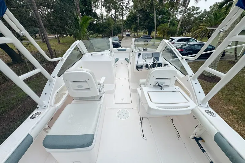 Slide: The Image of 2014 Everglades 230 Dual Console boat interior with seating and steering wheel. - 28