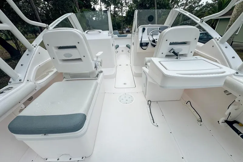 Slide: The Image of 2014 Everglades 230 Dual Console boat interior with seating and steering wheel. - 30