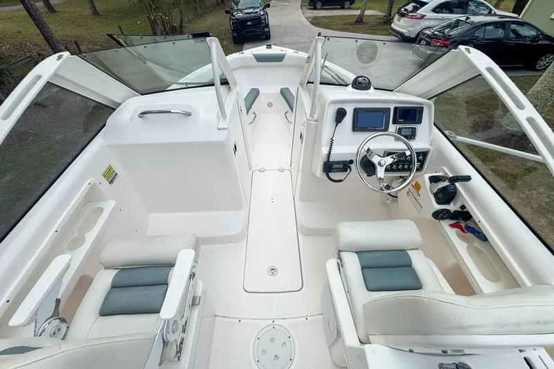 Slide: The Image of 2014 Everglades 230 Dual Console boat interior with steering wheel and seating. - 33