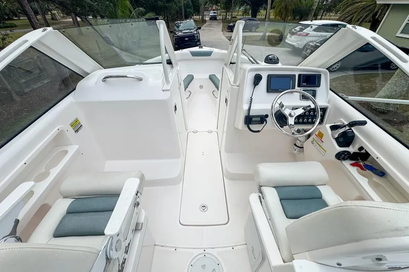 Slide: The Image of 2014 Everglades 230 Dual Console boat interior with steering wheel and seating. - 34