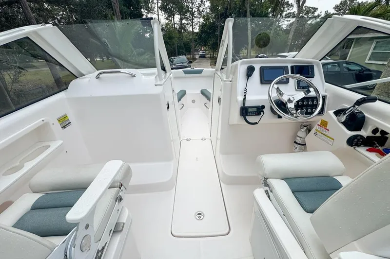 Slide: The Image of 2014 Everglades 230 Dual Console boat interior with steering wheel and seating. - 35