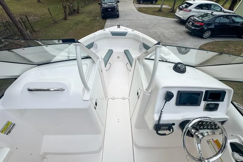 Slide: The Image of 2014 Everglades 230 Dual Console boat interior with steering wheel and dashboard controls. - 36
