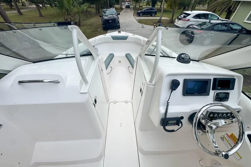 Slide: The Image of 2014 Everglades 230 Dual Console boat interior with steering wheel and navigation equipment. - 37