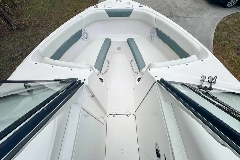 Slide: The Image of 2014 Everglades 230 Dual Console boat interior with cushioned seating and open deck. - 39