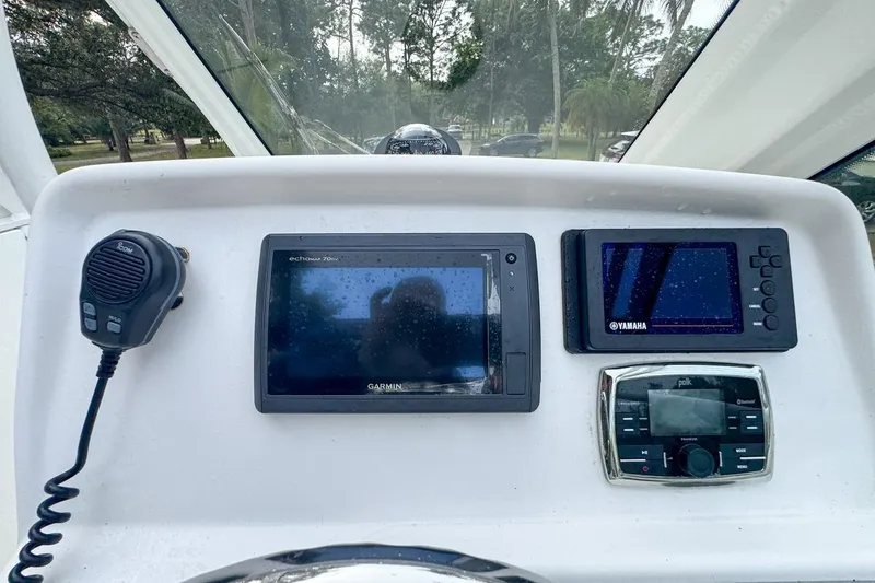 Slide: The Image of Dashboard of 2014 Everglades 230 Dual Console with Garmin and Yamaha displays. - 42