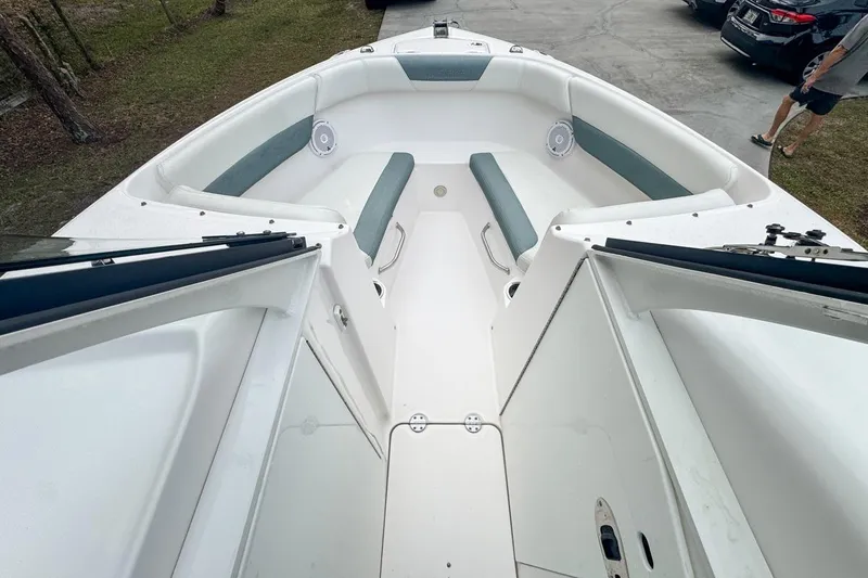 Slide: The Image of 2014 Everglades 230 Dual Console boat interior with seating and open deck view. - 46
