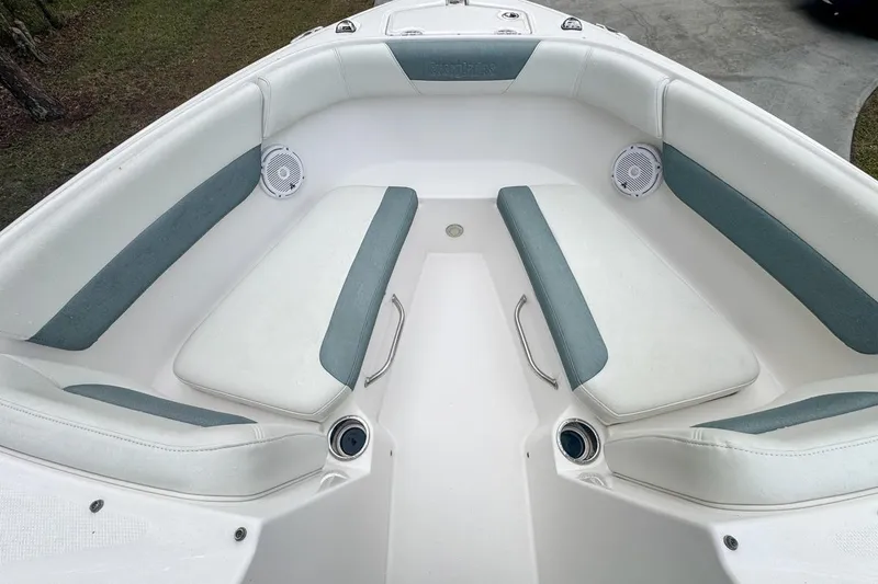 Slide: The Image of 2014 Everglades 230 Dual Console boat interior with cushioned seating and speakers. - 48