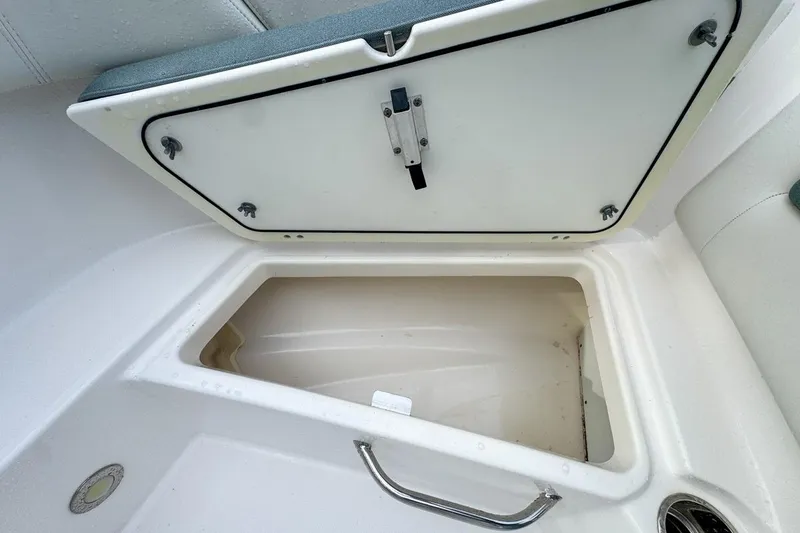 Slide: The Image of Open storage compartment on 2014 Everglades 230 Dual Console boat. - 50