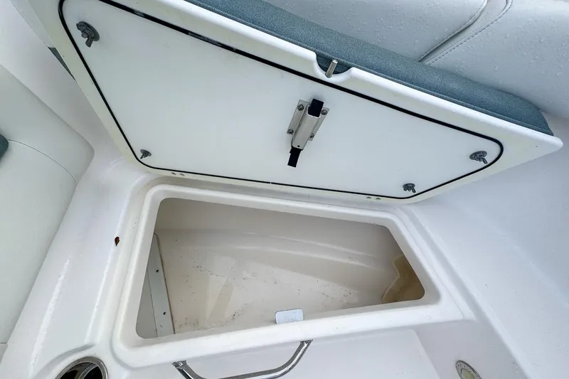 Slide: The Image of Open storage compartment on 2014 Everglades 230 Dual Console boat. - 51