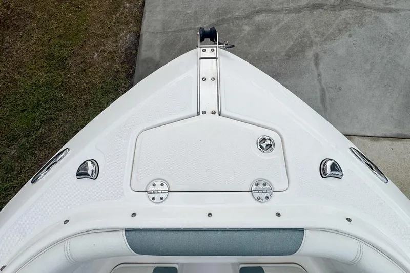 Slide: The Image of Bow of 2014 Everglades 230 Dual Console boat with sleek design and chrome fixtures. - 52